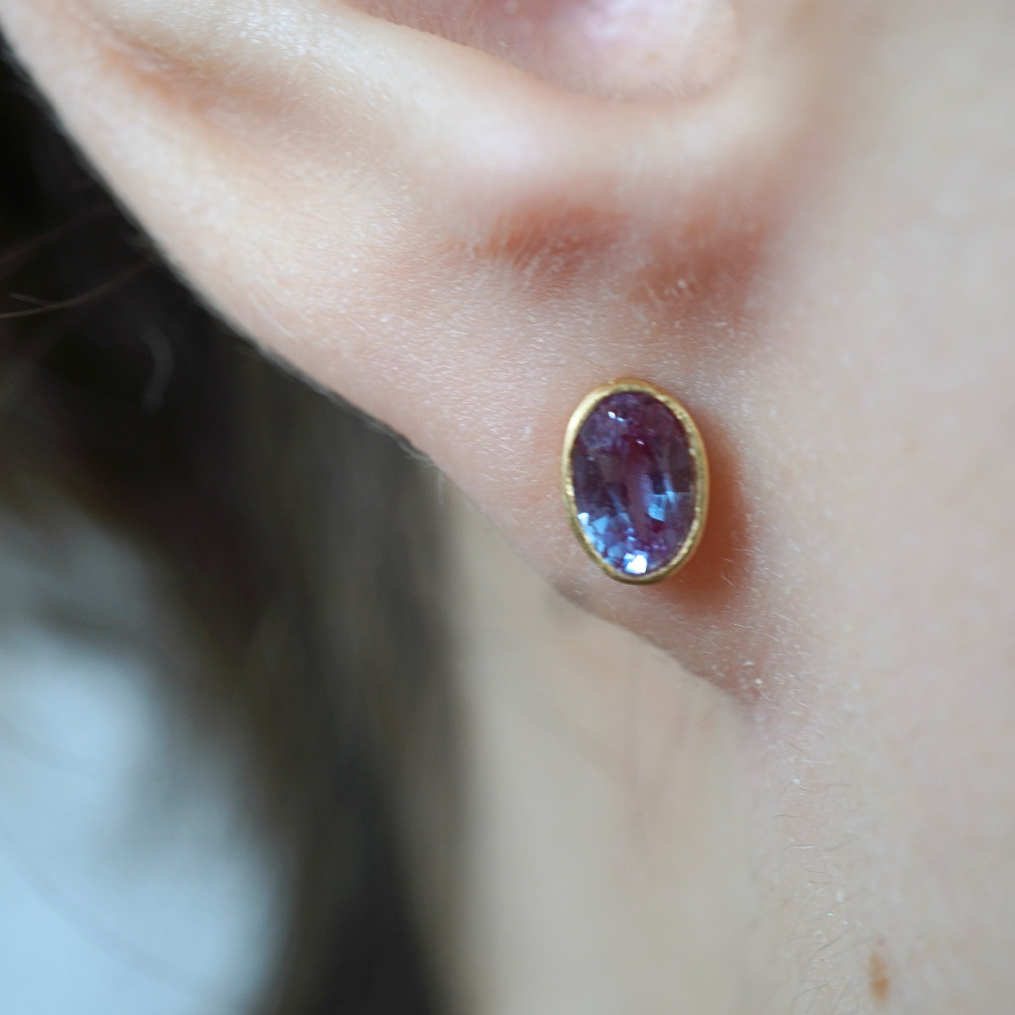 18ky gold alexandrite stud earring on model